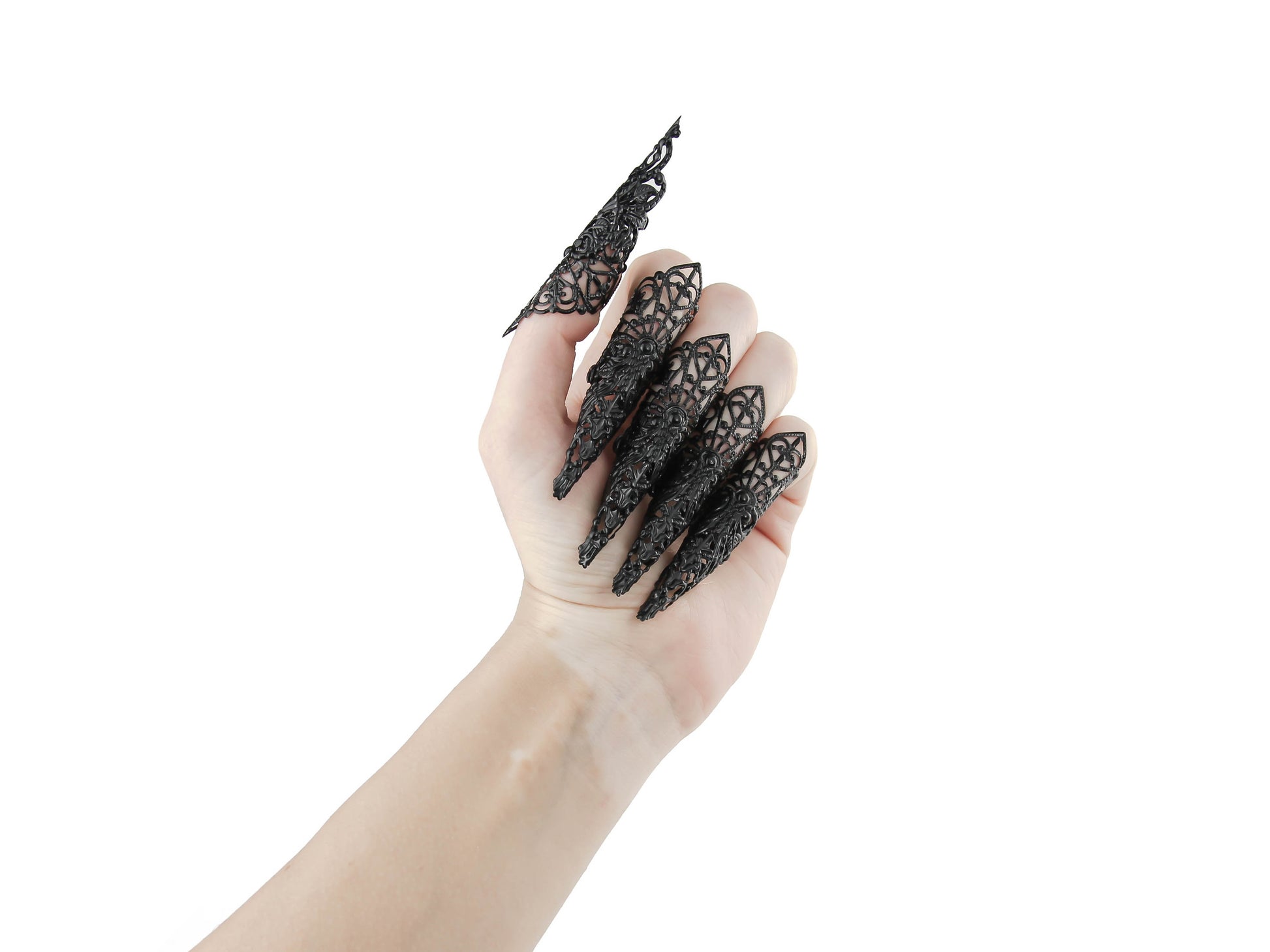 A full hand set of extra-long black nail claws by Myril Jewels showcases a bold neo-goth design, ideal for anyone with a love for dark, statement jewelry. Perfect for Halloween or as a standout accessory at a rave party, these claws encapsulate gothic-chic and witchcore styles, making them a unique gift for the goth girlfriend or for dramatic festival wear.