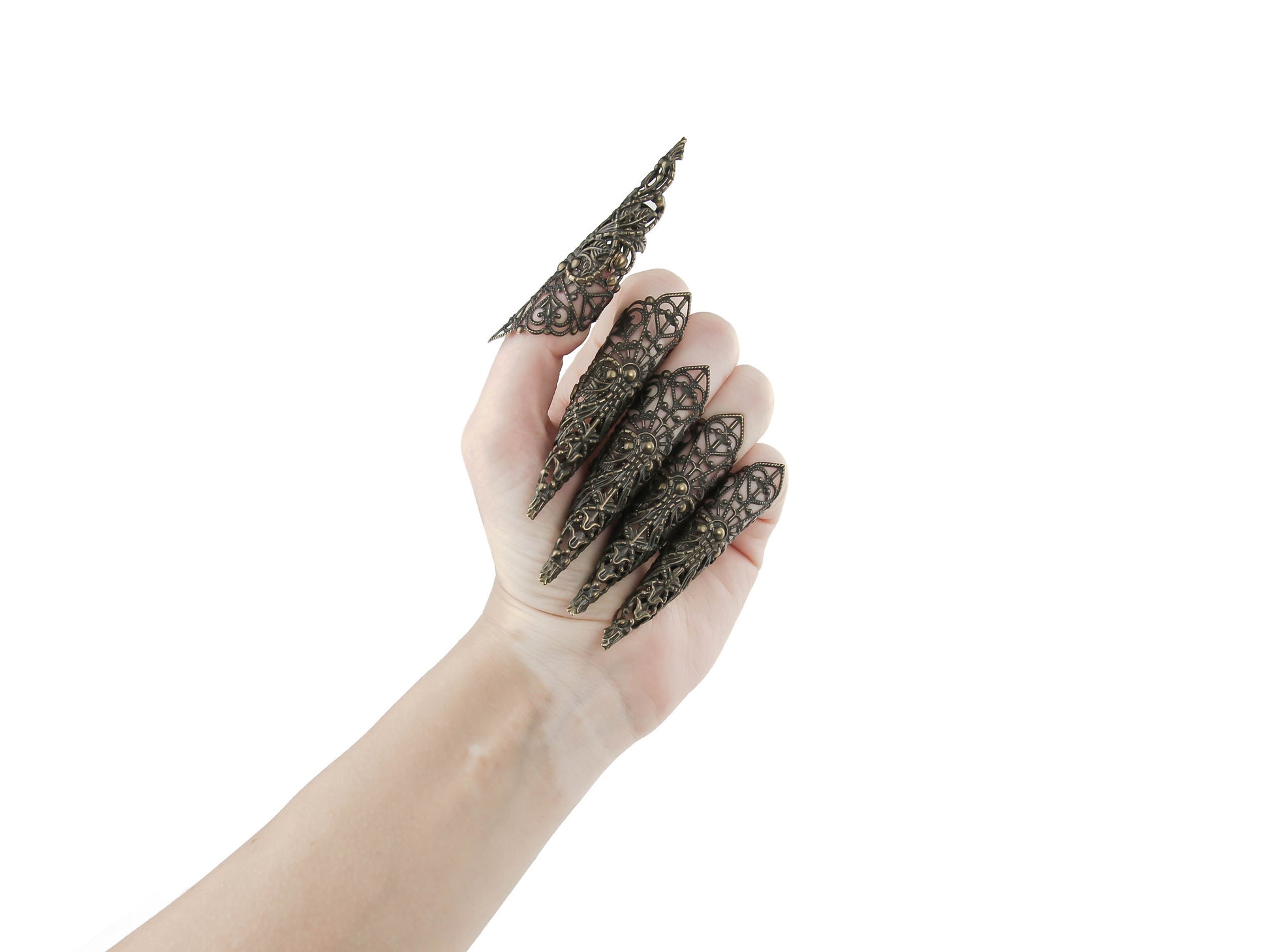 A full hand set of extra-long, intricately designed nail claws from Myril Jewels exudes a dark, neo-goth elegance. Ideal for Halloween, these claws are a bold choice for those who love punk jewelry, whimsigoth style, or witchcore. They're perfect for adding an avant-garde touch to everyday wear or as a statement at rave parties and festivals. These claws are also a unique gift idea for a goth girlfriend.