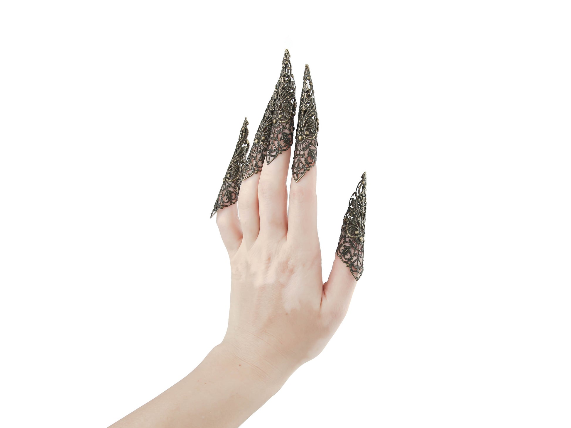 A full hand set of extra-long, intricately designed nail claws from Myril Jewels exudes a dark, neo-goth elegance. Ideal for Halloween, these claws are a bold choice for those who love punk jewelry, whimsigoth style, or witchcore. They're perfect for adding an avant-garde touch to everyday wear or as a statement at rave parties and festivals. These claws are also a unique gift idea for a goth girlfriend.